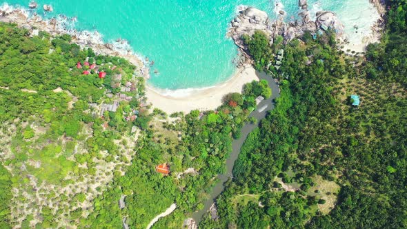 Tropical jungle rocky coast and secluded sandy beach near the Royal river, Koh phangan, Thailand