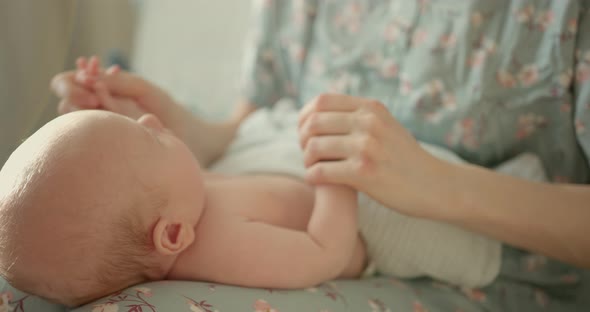 Holding Newborns Hand in Slow Motion