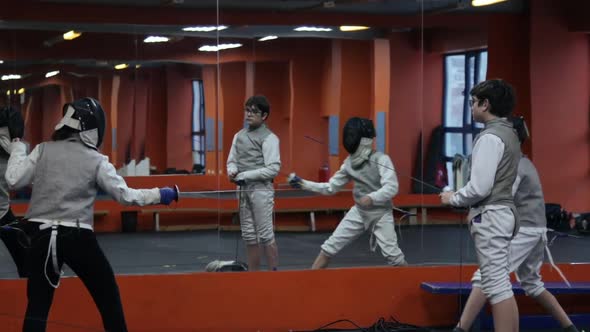 Kids practicing fencing at a fencing school