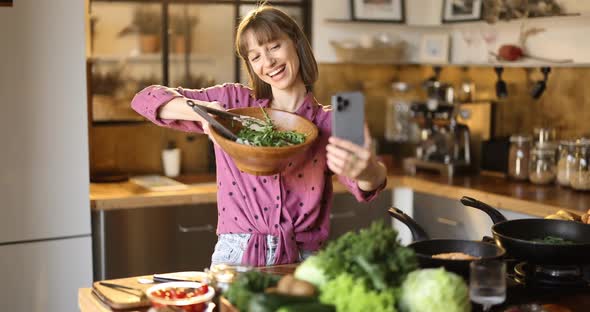 Woman Recording Video of Herself While Cooking Healthy in the Kitchen