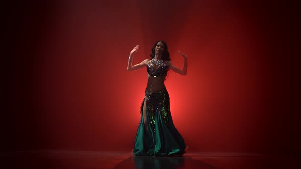 Torso of Woman Belly Dancer Dancing . Red Smoke Background