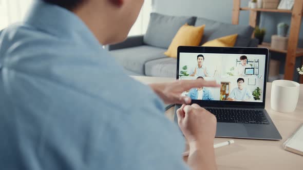 Asia businessman using laptop talk to colleagues about plan in video call meeting while work