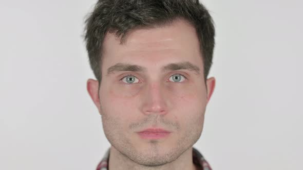 Close Up of Serious Young Man Looking at Camera