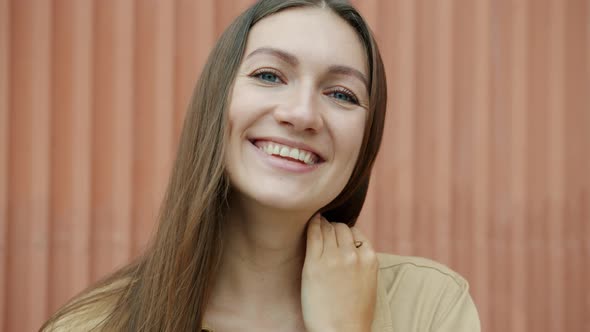 Closeup Portrait of Attractive Young Lady Smiling and Looking at Camera with Happiness and Joy