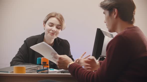 Woman  Telling What Is on the Documents and Man Is Listening