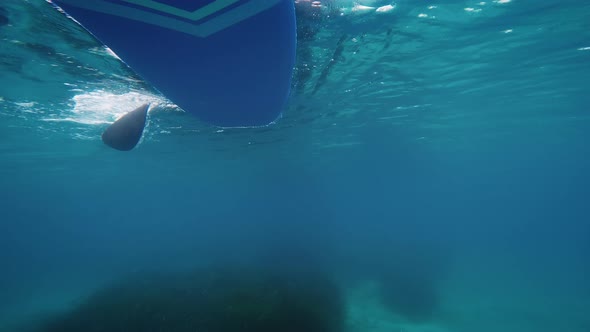 Oar of Stand Up Paddle Seen From Underwater in the Sea