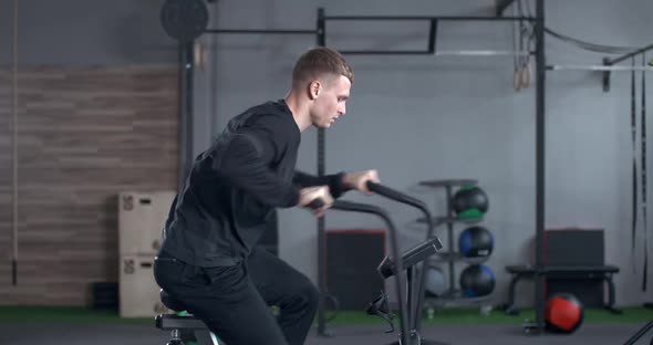Man Gym Young Man Trains Elliptical Bike Simulator Aerobic Exercise Endurance Training