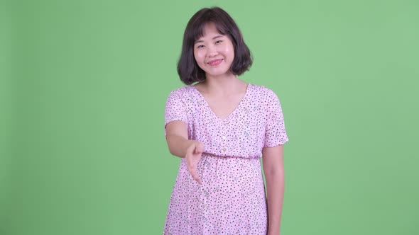 Happy Asian Pregnant Woman Giving Handshake