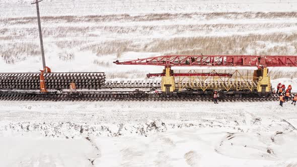 Aerial View UHD Railway Construction Machine Works in Winter. Railway Track Laying Machine, Railway