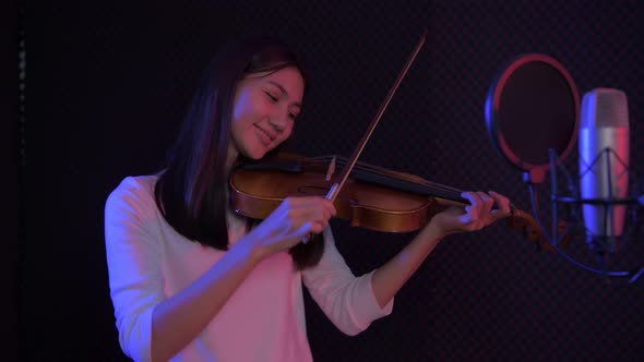 Audio recording concept, Asian girls playing violin in the studio, 4k Resolution