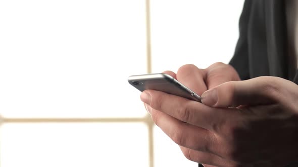 Closeup Man Hands Typing Something on His Smartphone