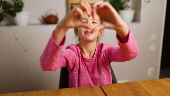 Little Girl Making Hearts From Hands Love