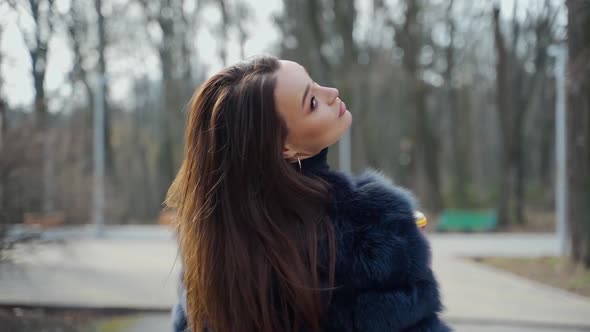 Happy dark haired girl in the park. 