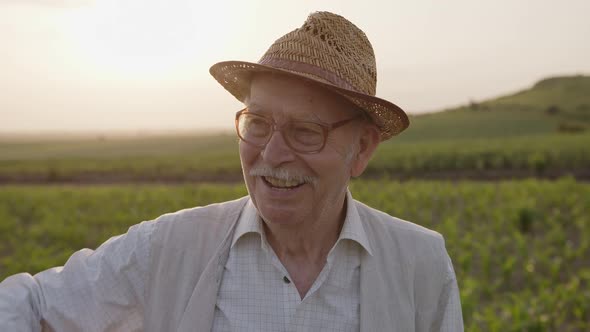 Close Up View of a Old Farmer in Hat and Glasses