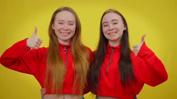 Medium Shot of Two Smiling Women Gesturing Thumbs Up Smiling Looking at Camera