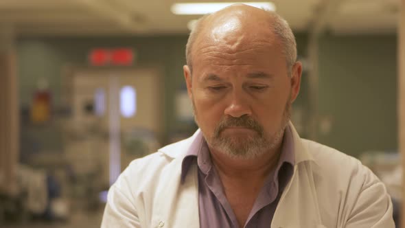 Doctor putting on medical rubber gloves in a hospital setting.