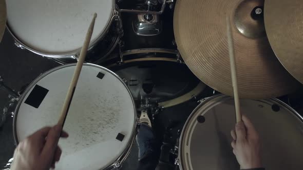 Man Sits Down to Play the Drum Set