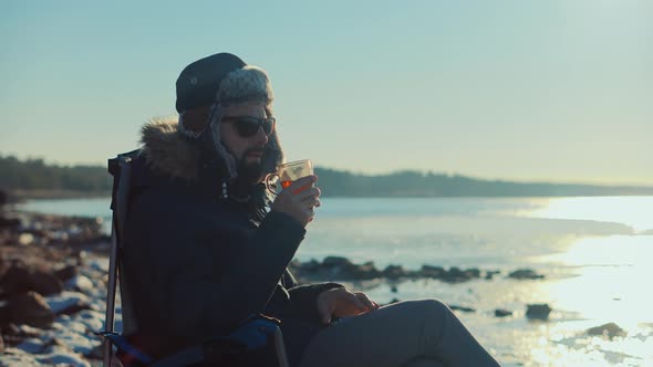 Man Warming Hands Steaming Cup Of Mate Tea. Male Hands With Mug Of Hot Drink Cold Winter Outdoors.