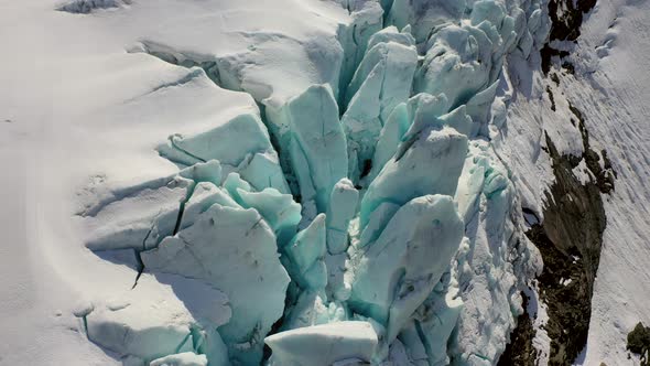 Aerial drone flight above stunning iced glacier mountain in Switzerland