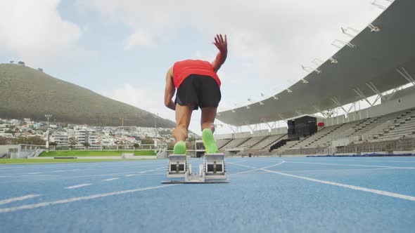 Caucasian athlete running in stadium