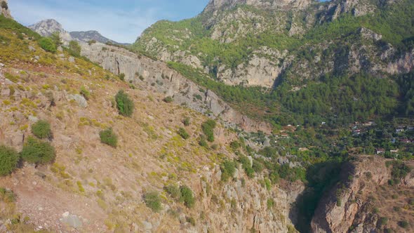 Tourists Man and Woman Stand on the Edge of a Cliff Butterfly Valley Canyon in Fethiye Turkey