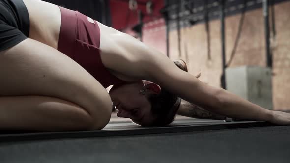 Sportswoman stretching in gym