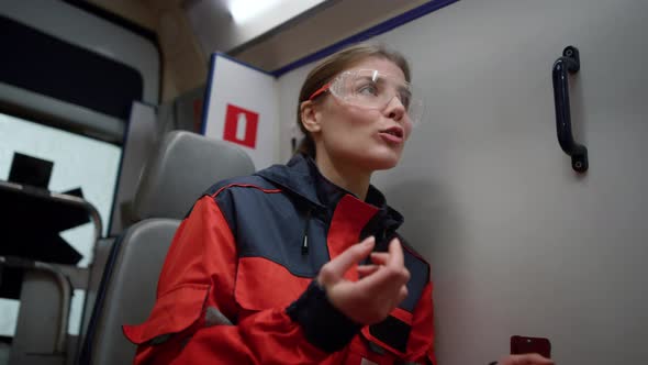 Paramedic Sitting in Emergency Vehicle