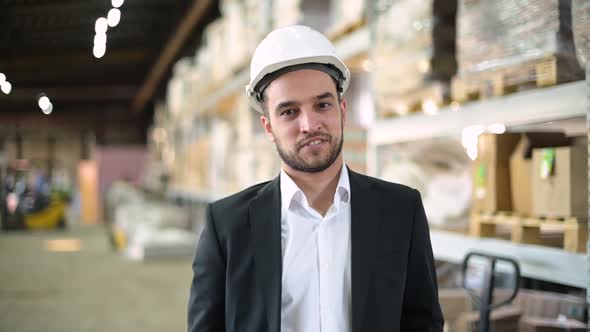 Portrait of a young man, a production manager. Young bearded boss smiling