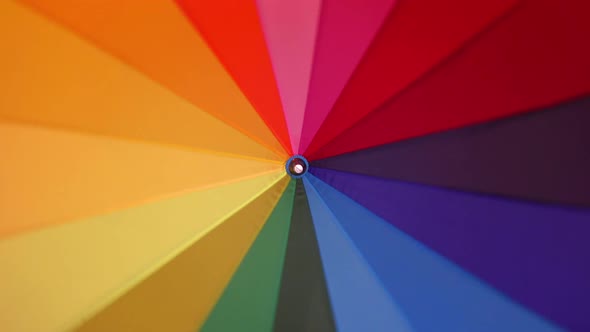 A Multi-colored Rainbow Umbrella Rotates alt