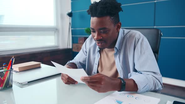 Young African American Man Reading Contract Happy to Receive Offer Company
