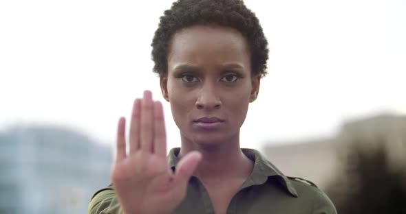 Portrait Decisive Mixed Race Girl Holding Palm in Front, Confidently Showing Prohibitory Gesture