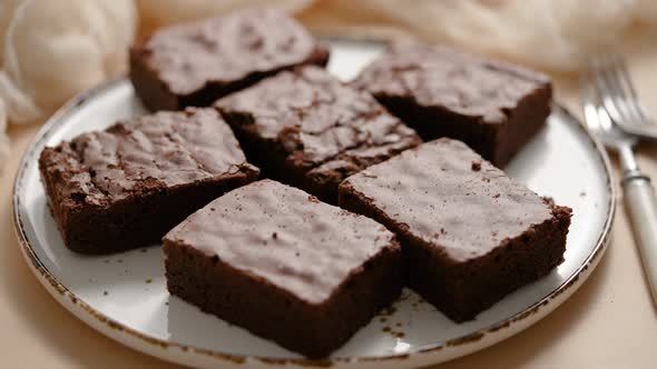 Delicious Homemade Chocolate Brownies Served on White Plate Over Beige Background