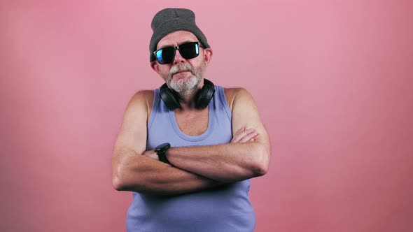 Cool aged man in trendy sunglasses and hat