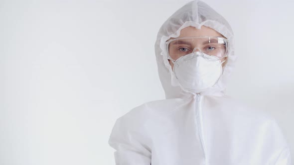 A Portrait of a Girl Epidemiologist Forbids Passing By, Raising Her Hand and Showing a Stop Sign. A alt