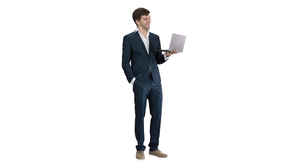 Very excited elegant man in suit standing with laptop in