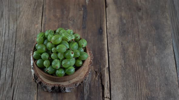 Green Gooseberries in a Wooden Bowl