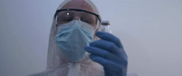 Person holding a vaccine bottle slow motion