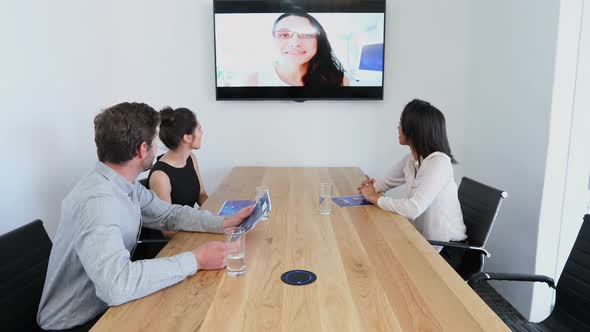 Business colleagues attending a video call in conference room 4k