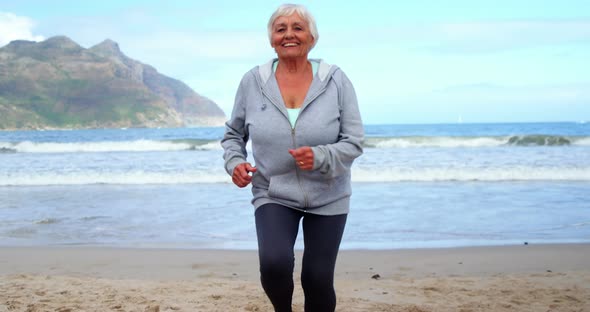 Senior woman jogging on the beach