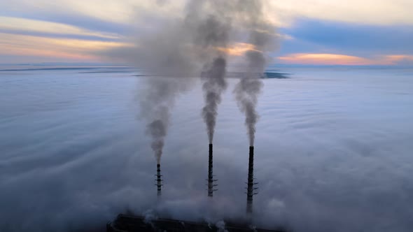 Coal Power Plant High Pipes with Black Smoke Moving Upwards Polluting Atmosphere