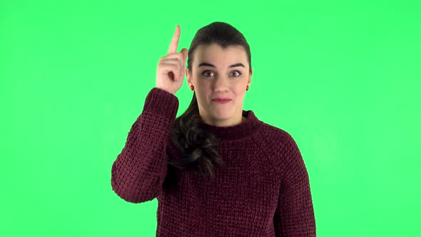 Cute Female Pointing Up Fingers. Green Screen