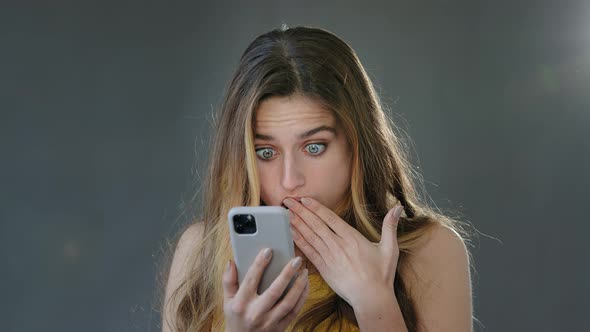 Emotional Shocked Surprised Amazed Blonde Woman Looking Smartphone Display Mobile Phone Open Mouth