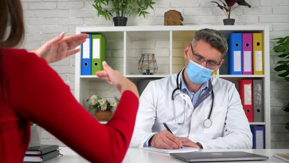 Doctor listens patient writes symptoms in notebook, woman talks health problems