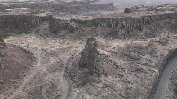 High bluffs and a large weathered Rock formation dominate Frenchman's Coulee, Wa, aerial orbit