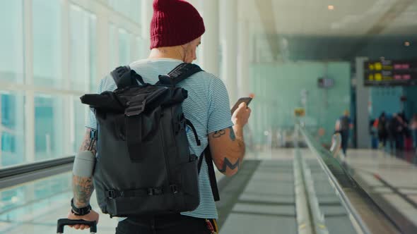 Modern Traveler in Big Empty Airport Goes To Gate