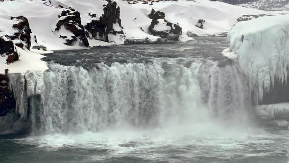 Goðafoss Waterfall in Winter, North Iceland, Close Up View of Water Flow Surrounded by Rocky Snowy W