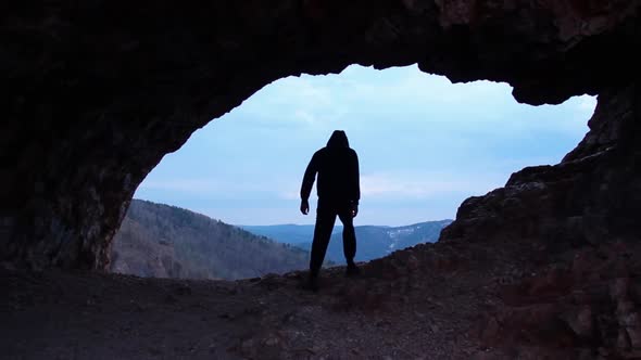 Silhouette of a Man Raising His Hands High in Arch on Top of the Big Mountain