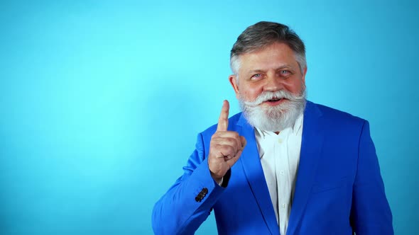 Funny senior man acting on a colored background