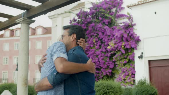 Slow Motion of Happy Gay Couple Hugging After Long Separation