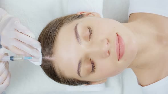 Woman Doing Special Procedure for Hair Restoration